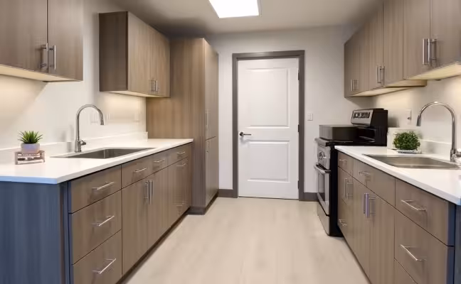 An accessible, modern kitchen featuring adjustable height counters and cabinets with easy-grip handles and knobs, non-slip flooring, and a spacious layout with wider doors and hallways to accommodate wheelchair or walker access